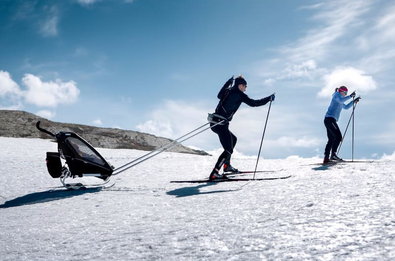 Går på ski på fjellet med Thule Chariot barnevogn på ski
